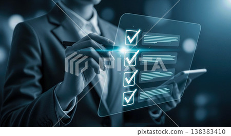 Businessman holding futuristic glowing digital tablet showing completed checklist marks representing corporate task management successful business planning modern technology strategy goals Businessman holding futuristic glowing digital tablet showing completed checklist marks representing corporate task management successful business planning modern technology strategy goals 138383410