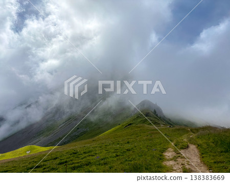 Fog covering alpine ridge in Les Contamines-Montjoie, France 138383669