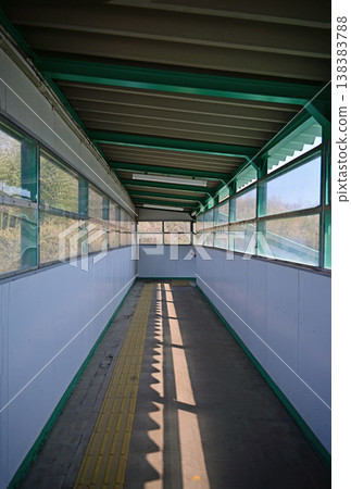 Inside the overpass of an unmanned station, tactile paving blocks and the shadows cast by sunlight, Suekawa Station on the JR Joban Line, Iwaki City, Fukushima Prefecture. Inside the overpass of an unmanned station, tactile paving blocks and the shadows cast by sunlight, Suekawa Station on the JR Joban Line, Iwaki City, Fukushima Prefecture. 138383788