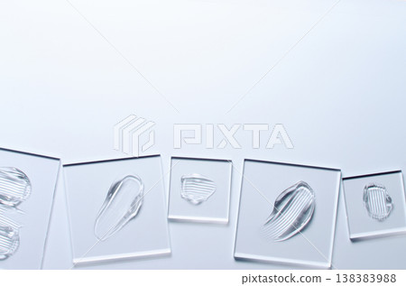 A sample of a transparent cosmetic skin care product on glass. Blue background 138383988
