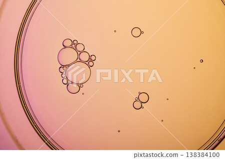 Oil bubbles creating an abstract pattern on liquid surface with pink and orange colors Oil bubbles creating an abstract pattern on liquid surface with pink and orange colors 138384100