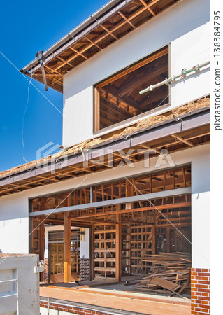 Demolition site of an old wooden house 138384795