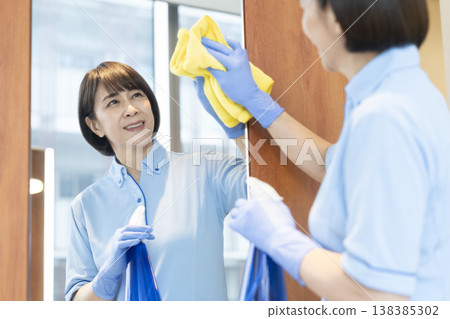 Senior female cleaning staff wiping surfaces 138385302