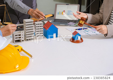 Concept of construction law, real estate development, renewable energy housing, and engineering collaboration. Concept of construction law, real estate development, renewable energy housing, and engineering collaboration. 138385824