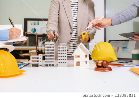 Concept of construction law, real estate development, renewable energy housing, and engineering collaboration. Concept of construction law, real estate development, renewable energy housing, and engineering collaboration. 138385831