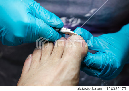 Professional Pedicure Procedure. Nail Technician Using Nail Clippers. Professional nail care service showing precise toenail cutting technique. Nail clippers. Professional Pedicure Procedure. Nail Technician Using Nail Clippers. Professional nail care service showing precise toenail cutting technique. Nail clippers. 138386475