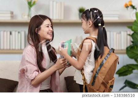 Parent assisting child with school preparation Parent assisting child with school preparation 138386510