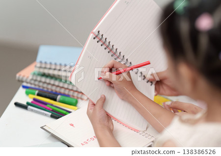 Child Writing Letters in Notebook for Back to School Child Writing Letters in Notebook for Back to School 138386526