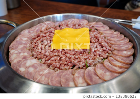Korean Army Base Stew (Budae-jjigae) Ingredients with Sausage, Minced Pork, and Cheese in a Pot 138386622