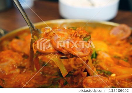 Korean Spicy Army Base Stew (Budae-jjigae) with Ham and Sausage on a Ladle Korean Spicy Army Base Stew (Budae-jjigae) with Ham and Sausage on a Ladle 138386692