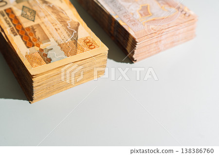 Two stacks of 1000 Kazakhstani tenge banknotes with different designs on green background, finance concept with copy space Two stacks of 1000 Kazakhstani tenge banknotes with different designs on green background, finance concept with copy space 138386760