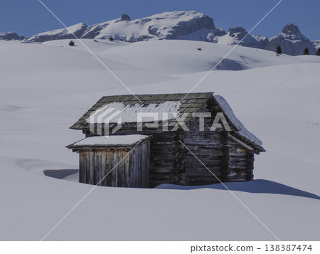 wooden hut covered by snow in armentarola pralongia dolomites mountains panorama 138387474