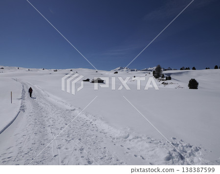 trekker near wooden hut covered by snow in armentarola pralongia dolomites mountains trekker near wooden hut covered by snow in armentarola pralongia dolomites mountains 138387599
