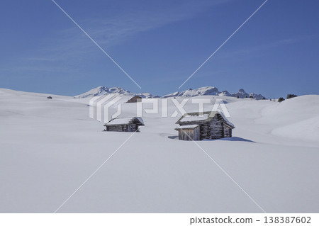 wooden huts covered by snow in armentarola pralongia dolomites mountains 138387602