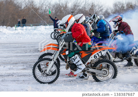 Group of motocross riders bursting off start line 138387687