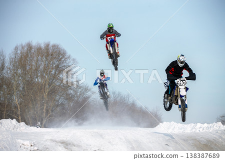 Three motocross riders jump Three motocross riders jump 138387689
