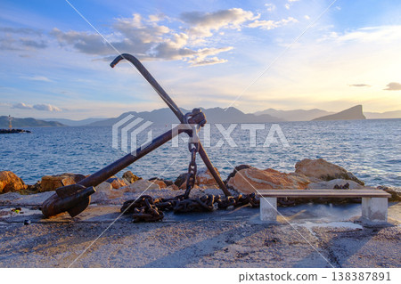 Rustic Anchor Sculpture by the Sea at Sunset in Aegina in Greece 138387891