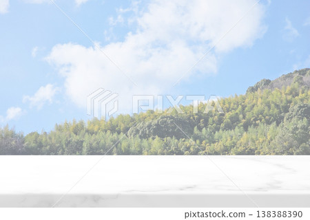 Marble Table with lush green forest on a hillside and cloudy blue sky 138388390