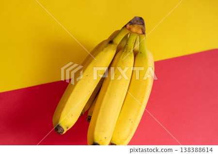 Bananas on a yellow and red background Bananas on a yellow and red background 138388614