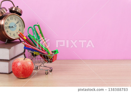 School supplies in shopping cart with apple and clock School supplies in shopping cart with apple and clock 138388783