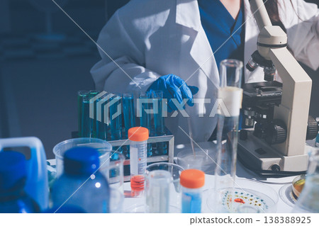 Science, laboratory and woman with pipette, test tube and biotech solution in research. Medical innovation, scientist or lab technician in study for healthcare, medicine and vaccine results feedback. 138388925