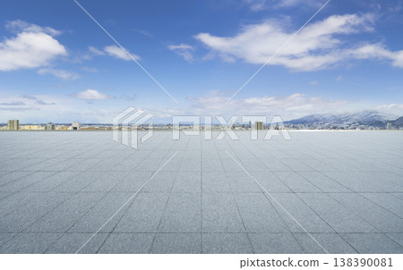 Empty tiled plaza with city skyline and snowy mountains Empty tiled plaza with city skyline and snowy mountains 138390081