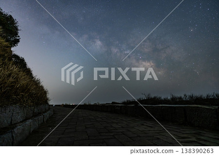 The beautiful Milky Way viewed from the seaside promenade. 138390263