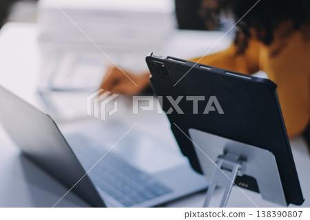 Pretty female freelancer working on laptop while sitting on modern coworking background Pretty female freelancer working on laptop while sitting on modern coworking background 138390807