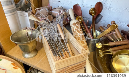 Elegant collection of professional kitchen utensils and carved rolling pin in a rustic boutique shop Elegant collection of professional kitchen utensils and carved rolling pin in a rustic boutique shop 138391089