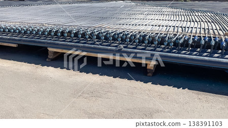Professional installation of modern industrial cooling system with HDPE pipes and manifold fittings Professional installation of modern industrial cooling system with HDPE pipes and manifold fittings 138391103