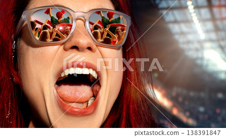 Excited woman with crowd reflected in sunglasses cheering at stadium event 138391847