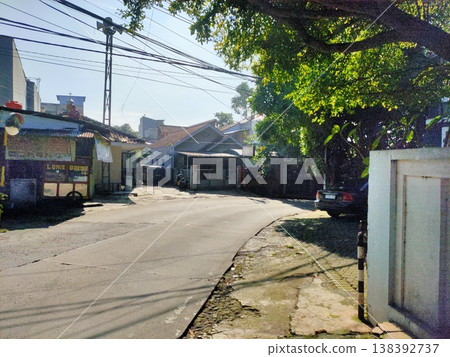 Curved quiet street with tiled roofs local charm blends greenery, signage, and everyday life. Curved quiet street with tiled roofs local charm blends greenery, signage, and everyday life. 138392737