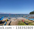 Colorful fishing boats rest under a bright blue sky on a peaceful tropical beach. 138392809