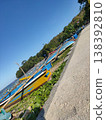 Colorful fishing boats rest under a bright blue sky on a peaceful tropical beach. 138392810