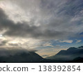 Misty morning mountains under dramatic skies, capturing the calm and mystery of nature dawn 138392854