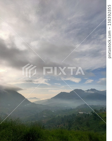 Misty morning mountains under dramatic skies, capturing the calm and mystery of natures dawn veil. Misty morning mountains under dramatic skies, capturing the calm and mystery of natures dawn veil. 138392855