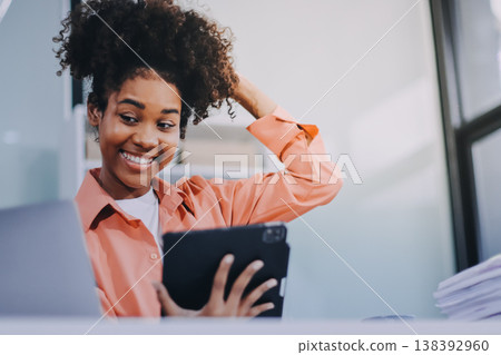 Smiling businesswoman working on laptop in office Smiling businesswoman working on laptop in office 138392960