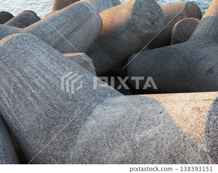 Stacked wave-dissipating blocks, the art of tetrapods, copy space 138393151