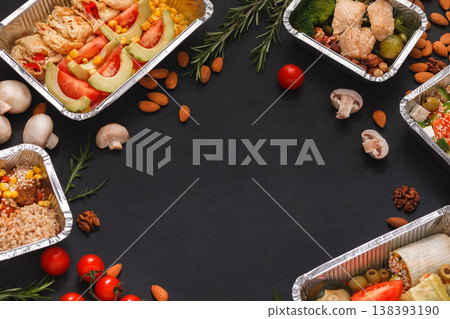 Healthy restaurant food delivery background with copy space. Mockup for menu, foil containers with meals on black Healthy restaurant food delivery background with copy space. Mockup for menu, foil containers with meals on black 138393190