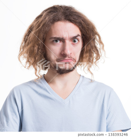 Facial expression and emotion. Embarrassed man looking at camera while standing on white isolated studio background, portrait Facial expression and emotion. Embarrassed man looking at camera while standing on white isolated studio background, portrait 138393246
