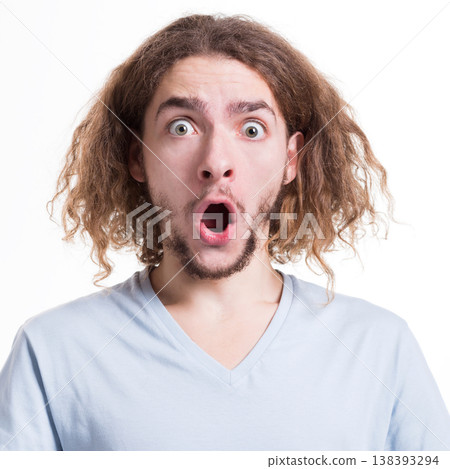 Shocking news. Wonder man expressing amaze on face, standing on white isolated background, studio shot Shocking news. Wonder man expressing amaze on face, standing on white isolated background, studio shot 138393294