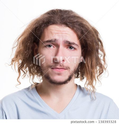 Feeling upset. Man with sad facial expression staring to camera on white isolated studio background, headshot Feeling upset. Man with sad facial expression staring to camera on white isolated studio background, headshot 138393328