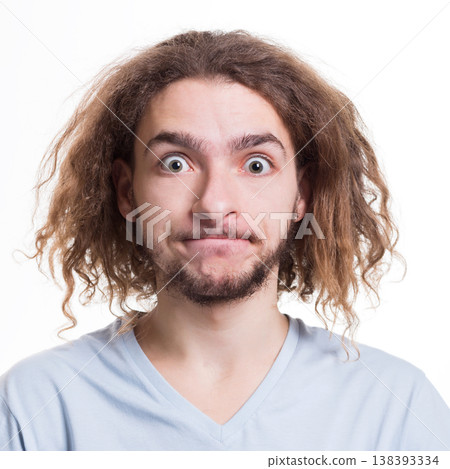 Portrait of man with surprised facial expression looking at camera while standing on white isolated studio background Portrait of man with surprised facial expression looking at camera while standing on white isolated studio background 138393334