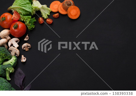 Healthy food background, fresh vegetables. Cooking ingredients for italian cuisine, top view on black Healthy food background, fresh vegetables. Cooking ingredients for italian cuisine, top view on black 138393338