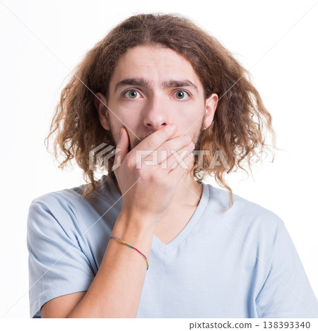 Keep silence. Gossip concept. Shocked man covering mouth with hand on white isolated studio background Keep silence. Gossip concept. Shocked man covering mouth with hand on white isolated studio background 138393340