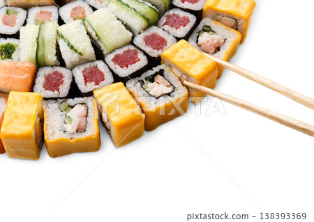 Japanese food restaurant delivery closeup - cheese sushi and rolls platter set isolated at white background with wooden chopsticks taking one piece 138393369