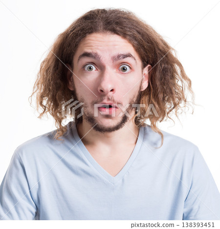 Surprised. Wonder man expressing amaze on face, standing on white isolated background, studio shot Surprised. Wonder man expressing amaze on face, standing on white isolated background, studio shot 138393451