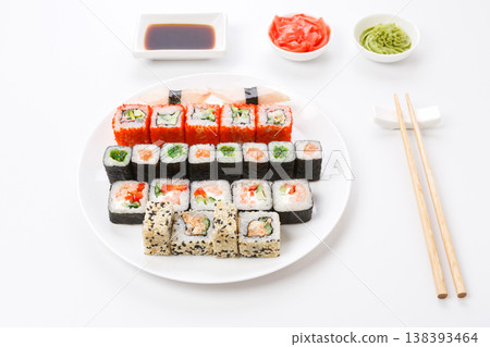 Japanese food restaurant, colorful rolls, gunkan and sushi platter. Set with chopsticks, soy sauce, ginger and wasabi on white background 138393464