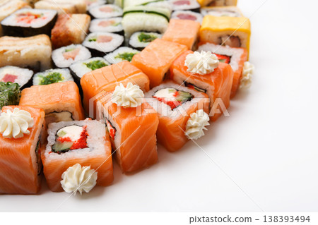 Japanese food restaurant delivery closeup - salmon sushi and rolls platter set isolated at white background Japanese food restaurant delivery closeup - salmon sushi and rolls platter set isolated at white background 138393494