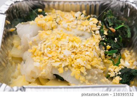 Healthy food restaurant delivery and diet concept. Take away meal in foil box. Egg salad with vegetables closeup Healthy food restaurant delivery and diet concept. Take away meal in foil box. Egg salad with vegetables closeup 138393532